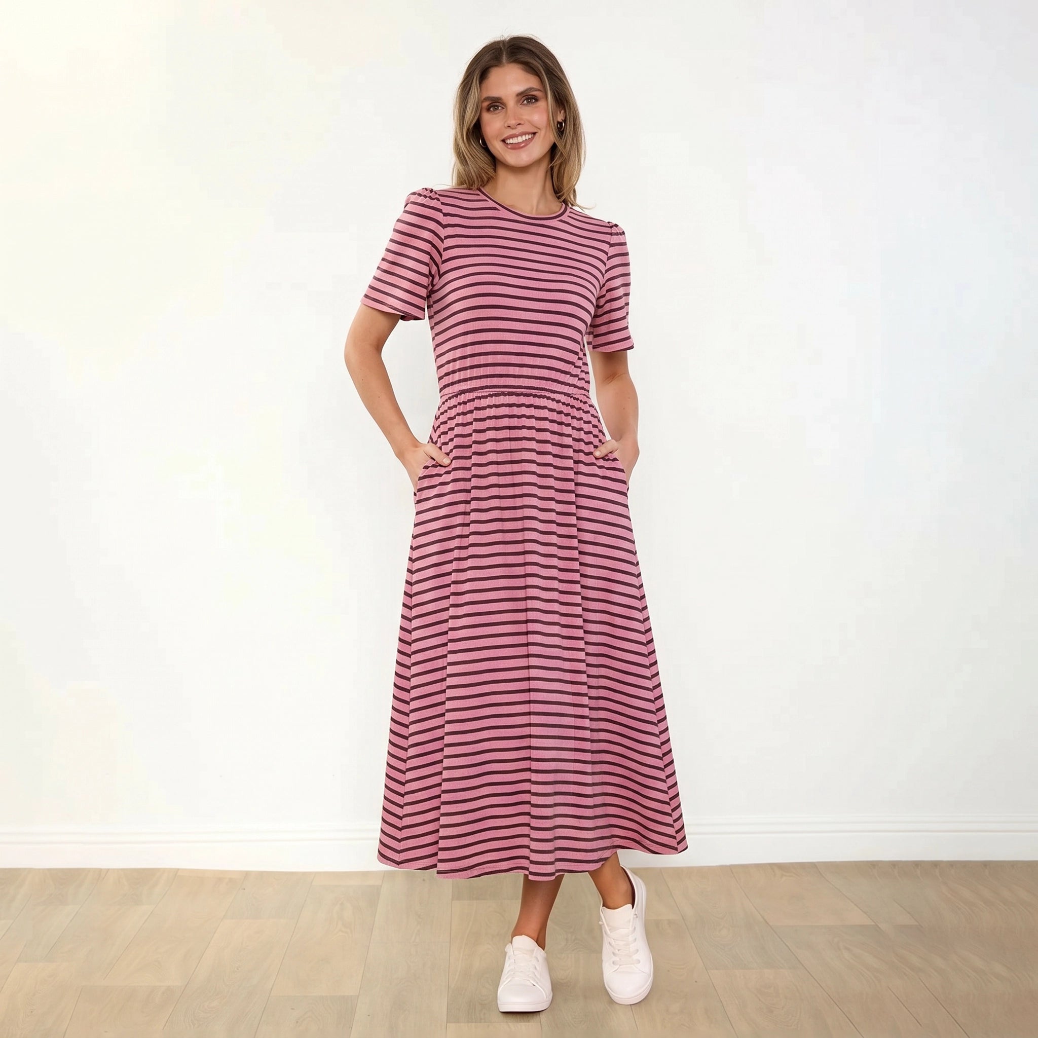 Eilish Dress (Pink/Brown) - Front, hands in pockets, warm smile