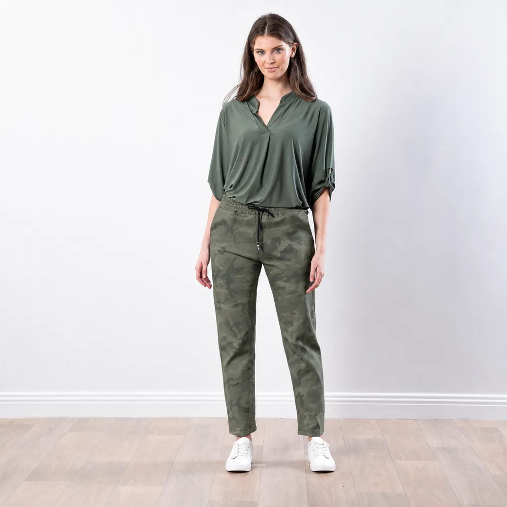 Stella Jogger in army camo print styled with an olive blouse and white trainers, relaxed front view
