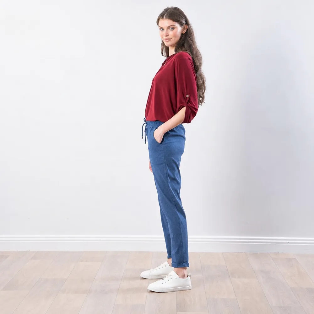 The Casual Company Stella Jogger in denim blue, side profile view showing tapered leg and side pocket