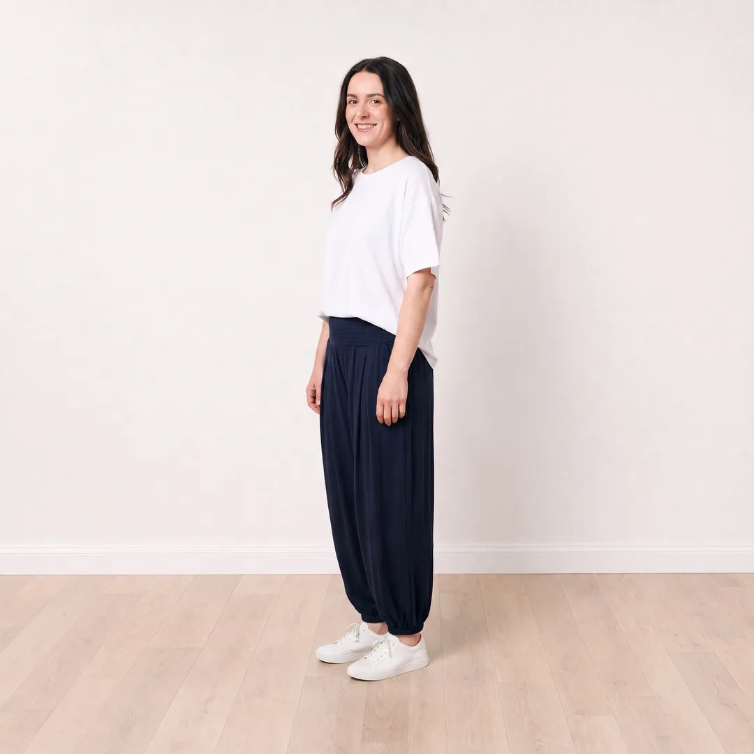 Orla Trousers in navy on T_Róisín, full side profile with white top