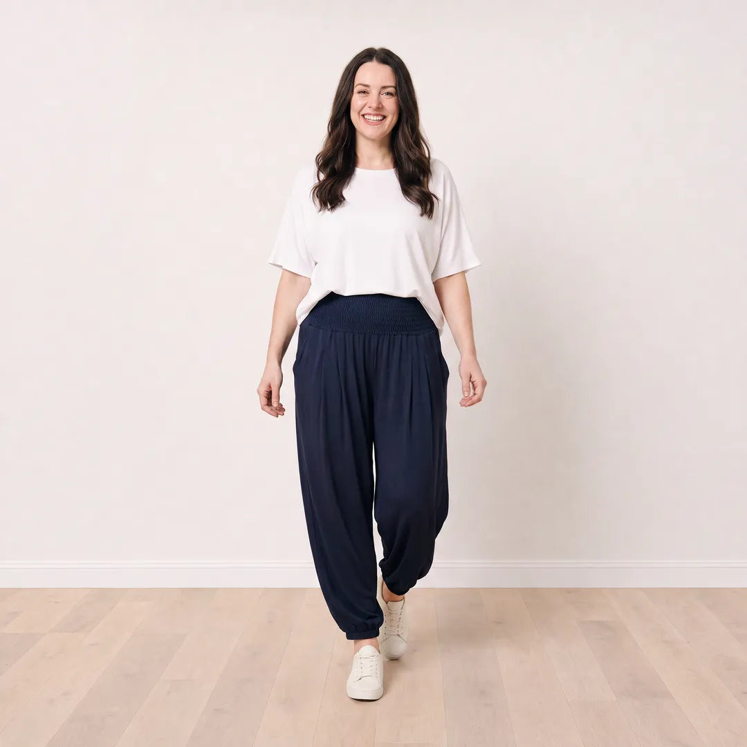 Orla Trousers in navy on T_Róisín, relaxed walking view with white top