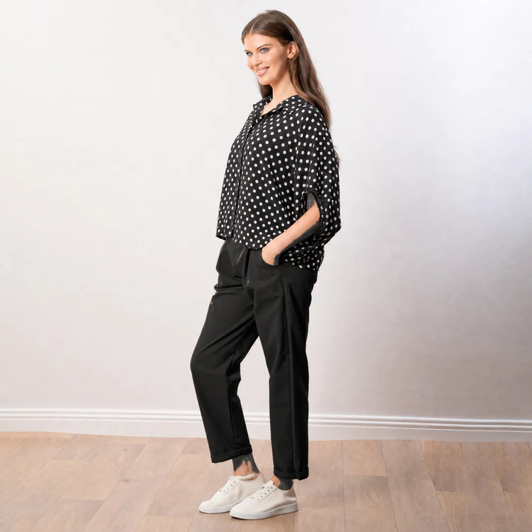 Athena Top in black polka dot, side profile view showing oversized boxy cut and sleeve detail