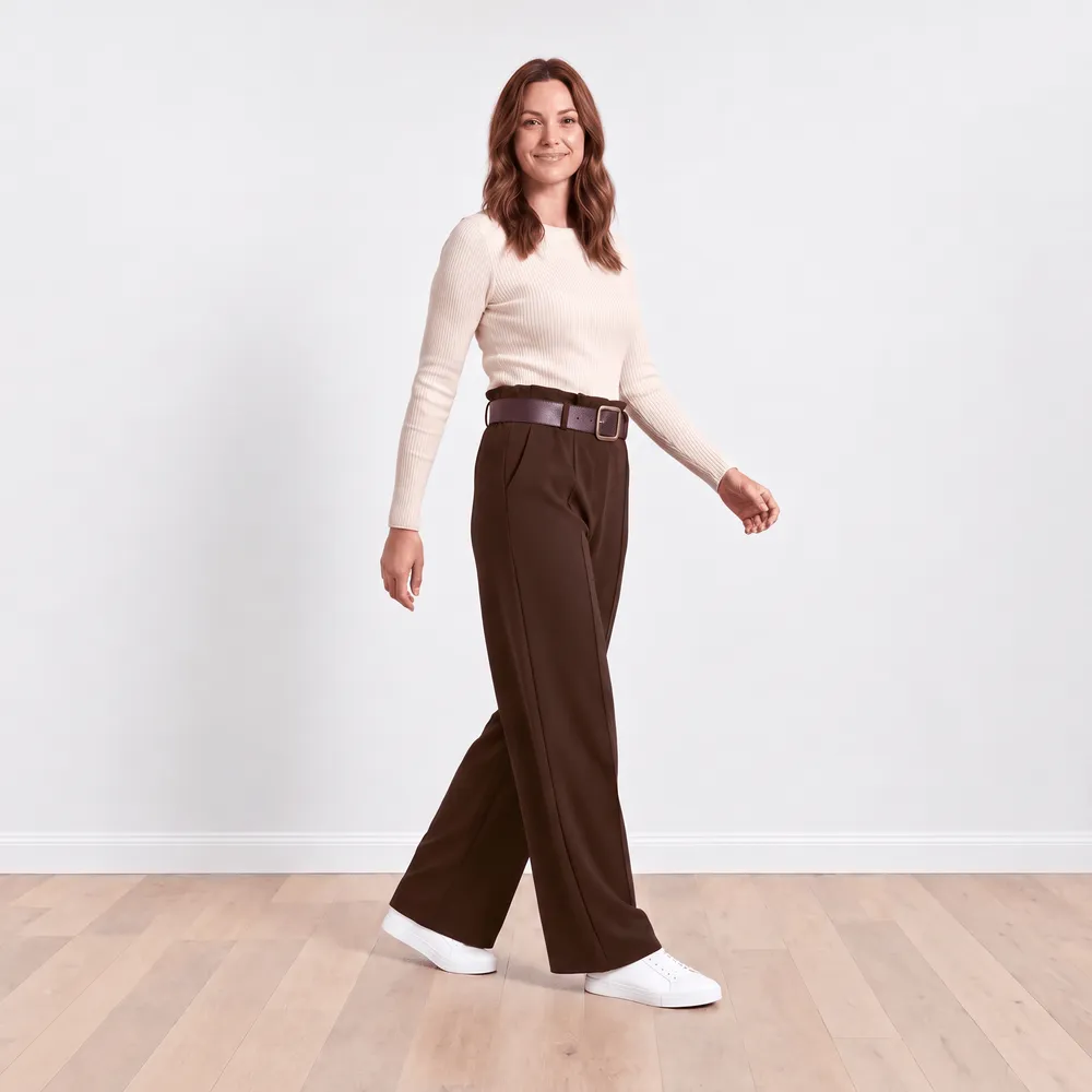 Ellana Trousers in brown — model walking, showing movement in the wide leg