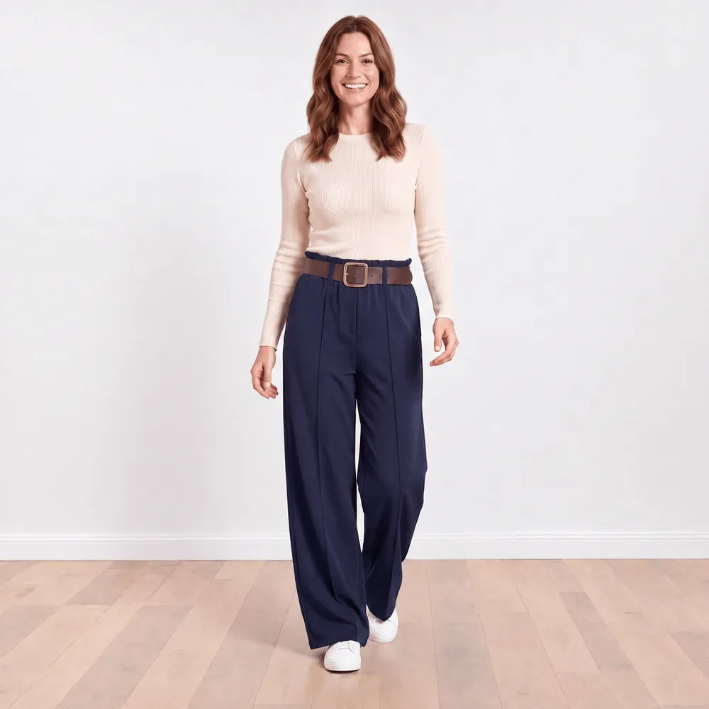 Navy Ellana wide-leg paperbag-waist trousers styled with a cream ribbed knit top and white trainers, full front view