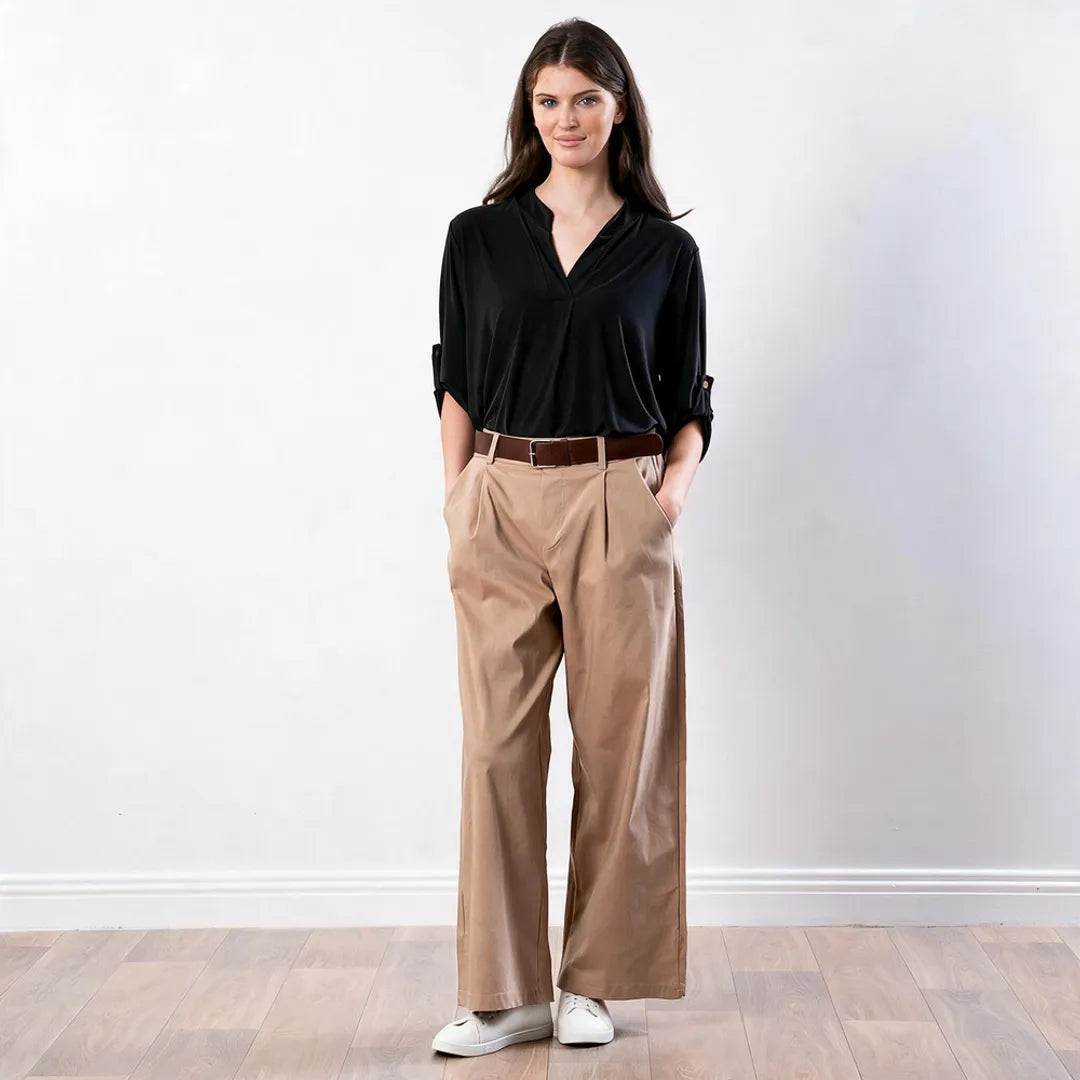 Sharlene Top in black — full-length front view styled with tan wide-leg trousers, brown belt and white trainers