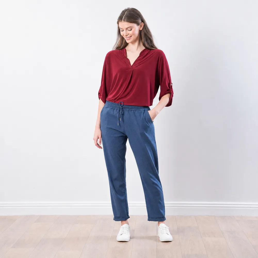 The Casual Company Stella Jogger in denim blue, relaxed front view showing drawstring waist and turned-up hem
